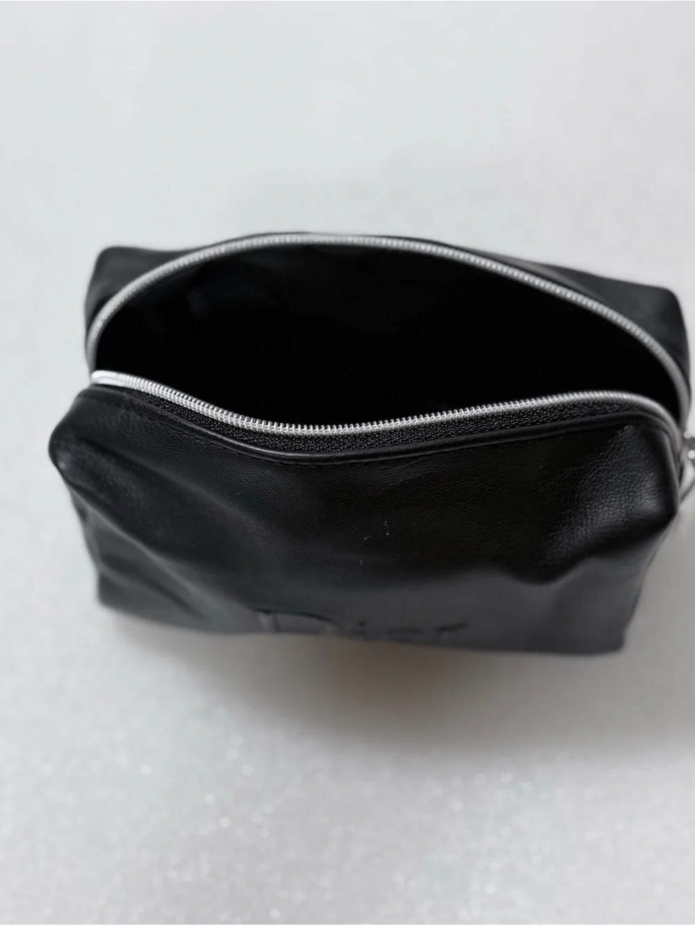 Dior makeup bag features a black exterior